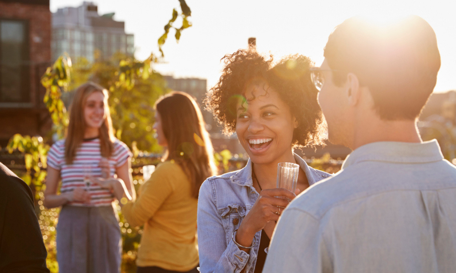 People enjoying a summer day party on their open rooftop terrace at Elora. Apartments in Meadowvale by Minto Apartments.
